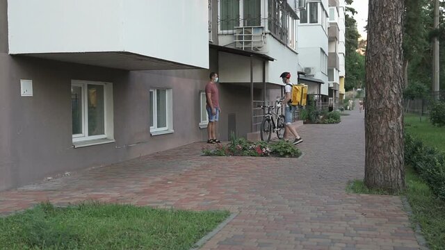 Courier delivery of food by bicycle during an outbreak of the virus. Coronavirus, COVID-19, safe delivery.	

