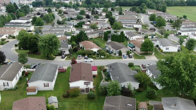 Mobile home, trailer park, manufactured housing, aerial reveal shot of single story low income housing in rural small town America, United States, poverty and population people theme