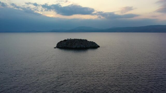 A small island in front of Vlychos Plakes Beach in Hydra Island, Greece