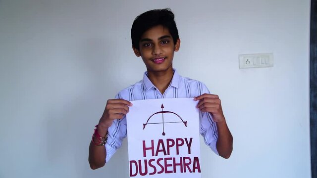 Boy show inscription "HAPPY DUSSEHRA" due to corona virus. Shot in 4k resolution.