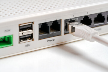 Internet cable connected to LAN port socket of router.