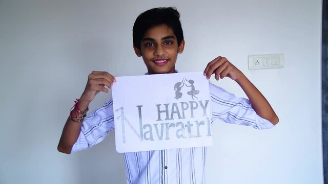 Boy show inscription "HAPPY NAVRATRI" due to corona virus. Shot in 4k resolution.