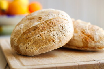 freshly baked rustic loaves of bread on wooden board