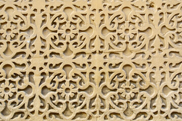 Textured sand stone wall with artistic curve elements. Building with outside rough ornate in Segovia, Spain