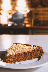 A slice of healthy cake with peanut butter and with nuts.