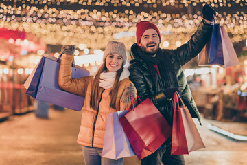 Black friday. Photo of two people students friends raise buy shopping bags under outside x-mas...