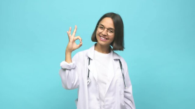 Young doctor indian woman cheerful and confident showing ok gesture
