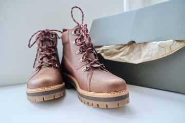 Fototapeta na wymiar New womens leather brown waterproof winter boots in box