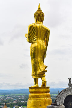 Gold Buddha statue on park.