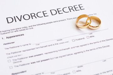 Two broken golden wedding rings divorce decree document. Divorce and separation concept	 - obrazy, fototapety, plakaty