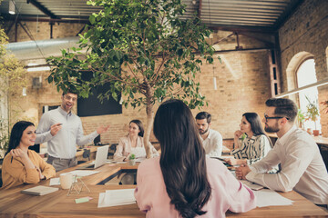 Photo of business men ladies people partners sitting around table spacious office seven members...