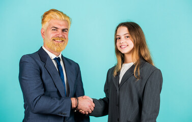Luxury and success. partnership. teamwork of daughter and dad. business meeting. modern office life. businessman dyed blond hair. small girl in oversized suit jacket. future career. family business