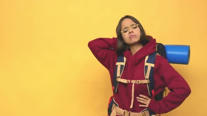 Young hiker indian woman touching back of head, thinking and making a choice