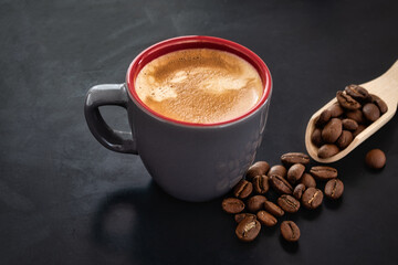 Coffee in a cup against the background of roasted coffee beans coffee on dark background.. classy coffee