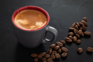 Coffee in a cup against the background of roasted coffee beans coffee on dark background.. classy coffee