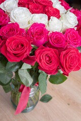 Multi-colored bouquet of red, pink and white roses in a vase