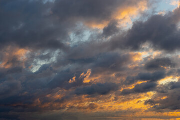 Beautiful morning sky, orange-gray clouds during sunrise.