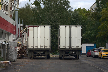 two vans on the platform at the service entrance to the store