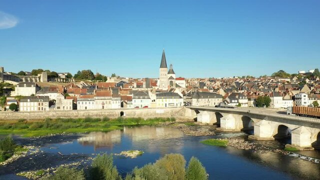 The Church of Charite sur Loire in front of the Loire bridge in Europe, France, Burgundy, Nievre, in summer, on a sunny day.