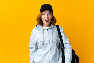 Young sport Georgian woman with sport bag over isolated background with surprise facial expression