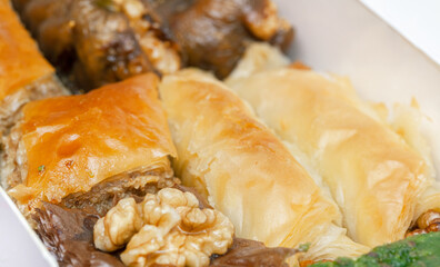 The famous desserts of Turkey. Baklava with walnut and chocolate, fig stuffed with walnut and pistachio roll and butterfly baklava in box. Taste of Turkish sweets world wide know.