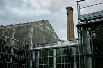 
old large greenhouse with a vertical chimney