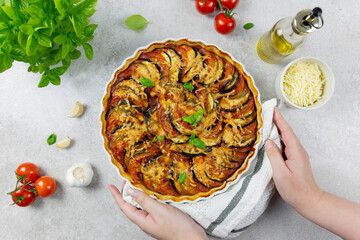 Healthy home vegan food concept. Baked organic vegetables. Traditional french dish ratatouille in a...