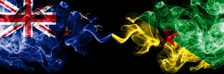 New Zealand vs French Guiana smoky mystic flags placed side by side. Thick colored silky abstract smoke flags