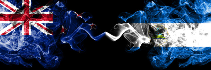 New Zealand vs Nicaragua, Nicaraguan smoky mystic flags placed side by side. Thick colored silky abstract smoke flags