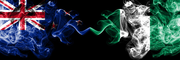 New Zealand vs Nigeria, Nigerian smoky mystic flags placed side by side. Thick colored silky abstract smoke flags