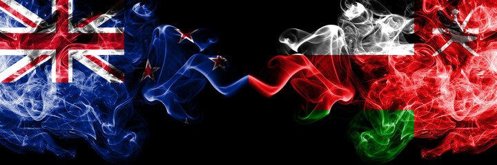 New Zealand vs Oman, Omani smoky mystic flags placed side by side. Thick colored silky abstract smoke flags