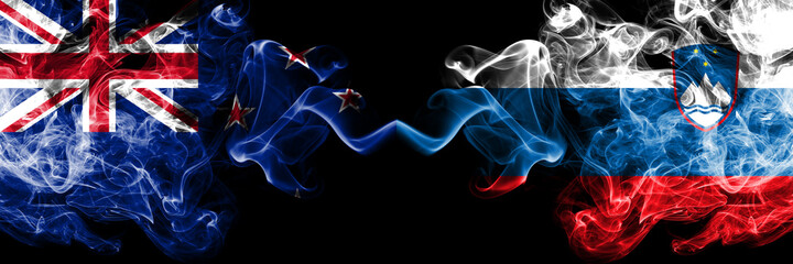 New Zealand vs Slovenia, Slovenian smoky mystic flags placed side by side. Thick colored silky abstract smoke flags