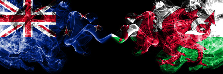 New Zealand vs Wales, Welsh smoky mystic flags placed side by side. Thick colored silky abstract smoke flags