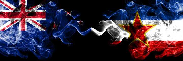 New Zealand vs Yugoslavia smoky mystic flags placed side by side. Thick colored silky abstract smoke flags