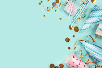 Birthday party supplies on blue background. Top view. Copy space.