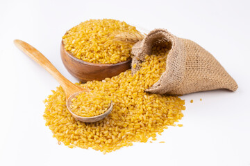 Heap of dry bulgur isolated on white