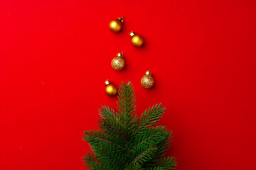 New year and Christmas background with fur tree branches on red background