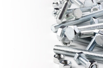 Lots of metal bolts and nuts. Tool for fixing. White background. Copy space