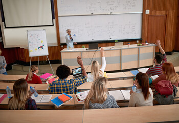 Female professor questioning students at a lecture