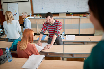 Student helping colleague in a break of a lecture