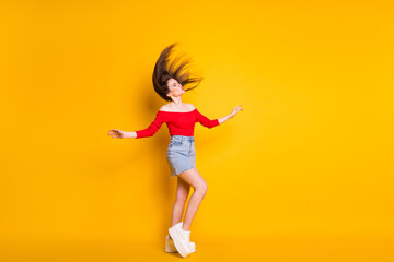 Fototapeta na wymiar Full length body size view of her she attractive pretty dreamy funky thin cheerful teen girl throwing hair having fun pout lips dance isolated over bright vivid shine vibrant yellow color background
