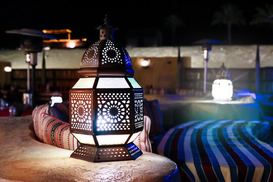 Classical And Retro  Arabia Styled Middle Eastern Lantern Lit At Night With Crafted Artwork Or Decorative Stained Glass With Metal Work Lantern Used In Festive Arabesque Seasons