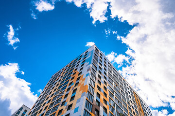 Fototapeta na wymiar Multi-storey residential modern house against the sky. Residential area.