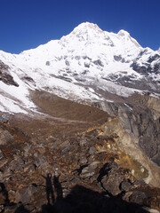 The snow-covered Himalayas and the shadow of the climbers, ABC (Annapurna Base Camp) Trek, Annapurna, Nepal