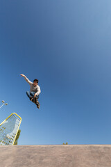 a roller skater jumps a ramp doing a trick in a skate park