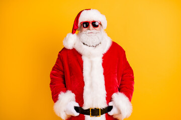 Fototapeta na wymiar Portrait of his he nice funny fashionable confident white-haired Santa holding belt wearing December fluffy look outfit isolated bright vivid shine vibrant yellow color background