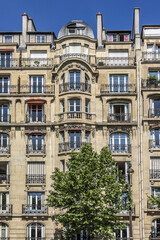 Fototapeta na wymiar Architecture of Paris: Old French house with traditional balconies and windows. Paris, France.