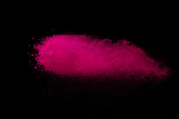 Pink powder explosion on black background. Paint Holi.