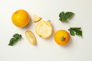 Round zucchini and leaves on white background