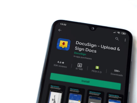Lod, Israel - July 8, 2020: DocuSign app play store page on the display of a black mobile smartphone isolated on white background. Top view flat lay with copy space.